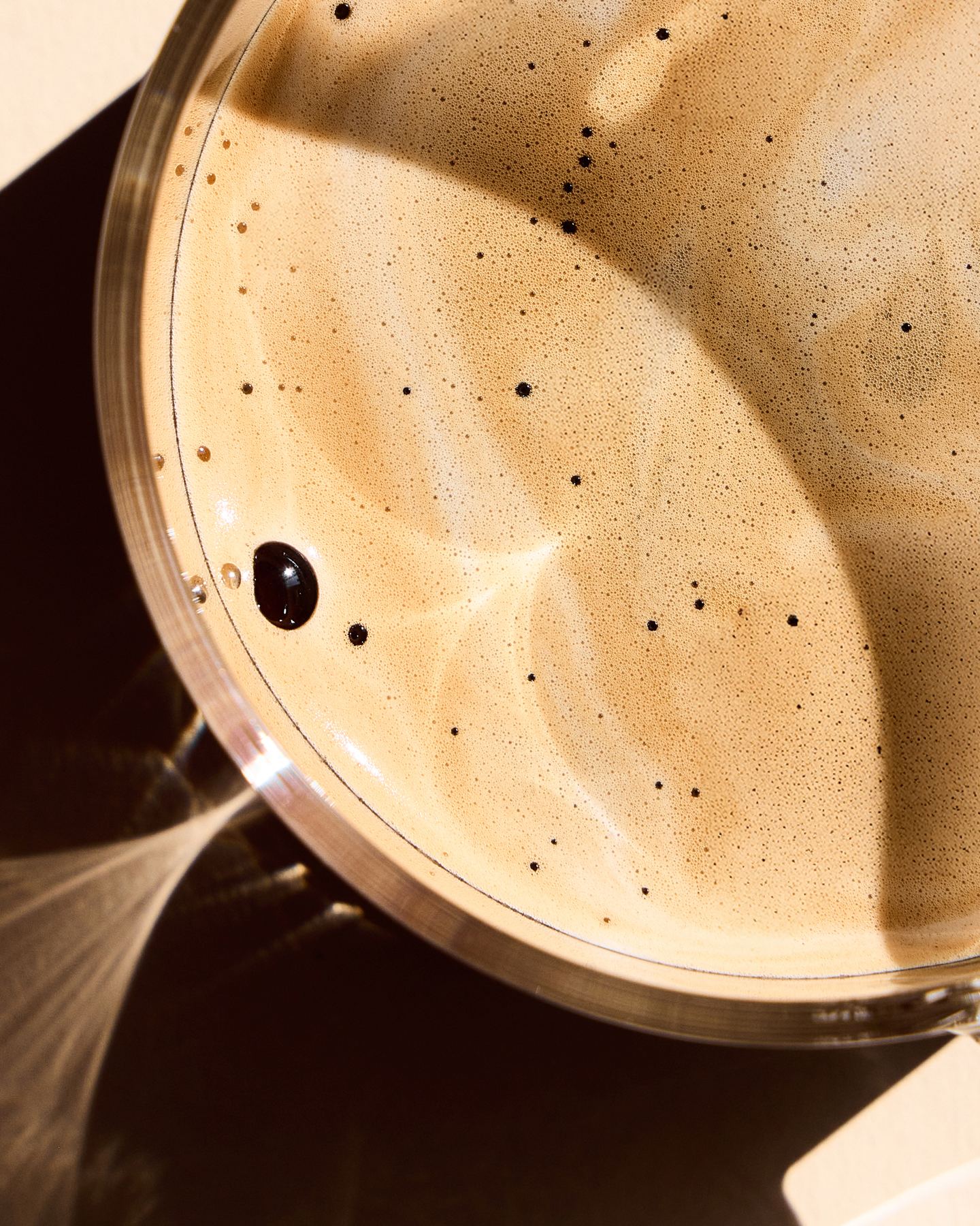 Crema and bubbles on the surface of a cup of coffee